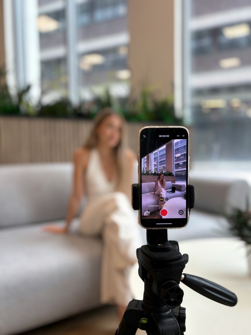 Creator filming herself on a phone tripod